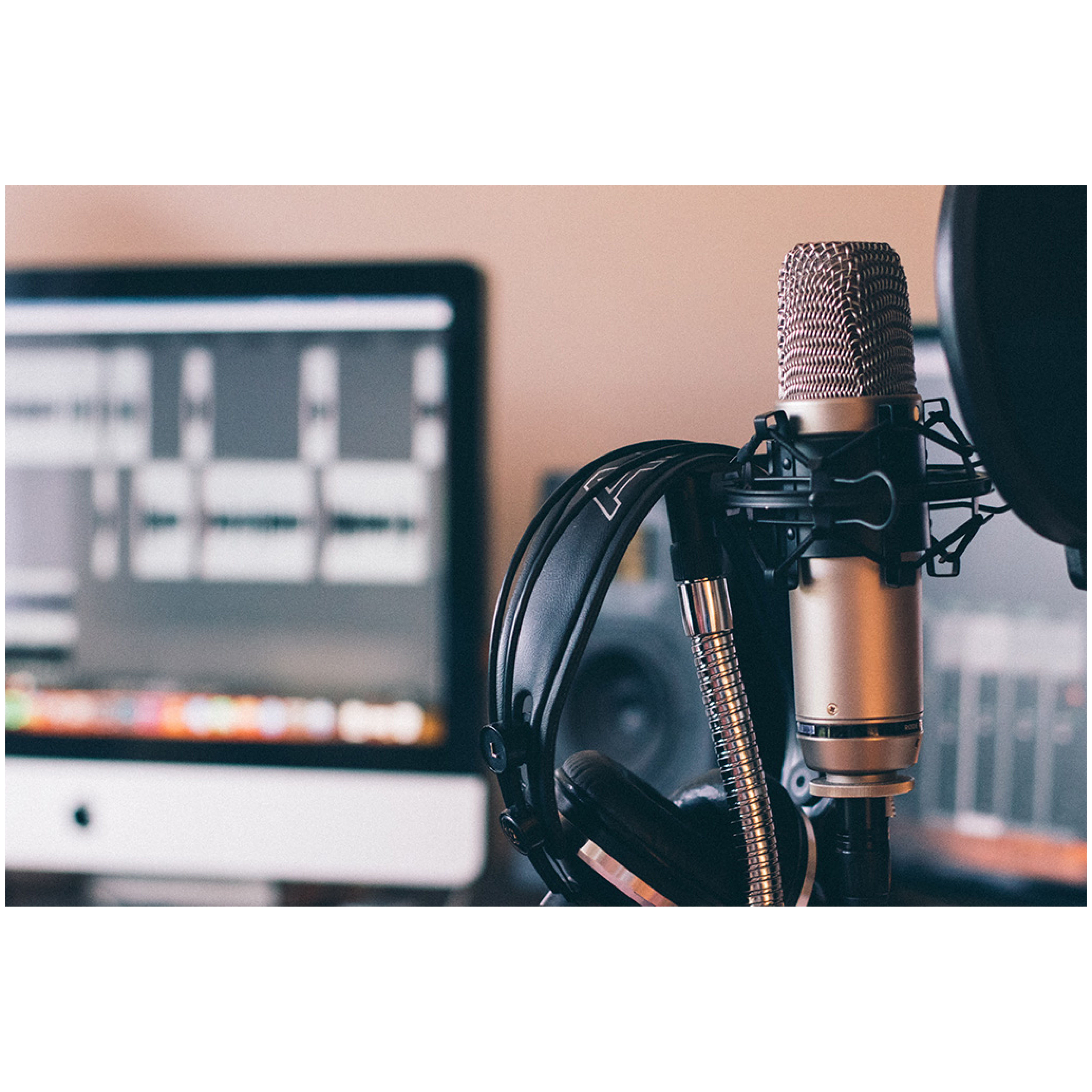 Image of a microphone against a podcast setup