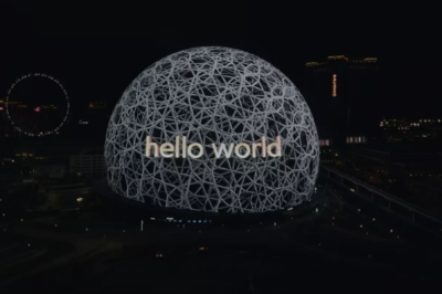 Top 5 Tech - the sphere in Abu Dhabi at night, showing the phrase 'hello world'. 