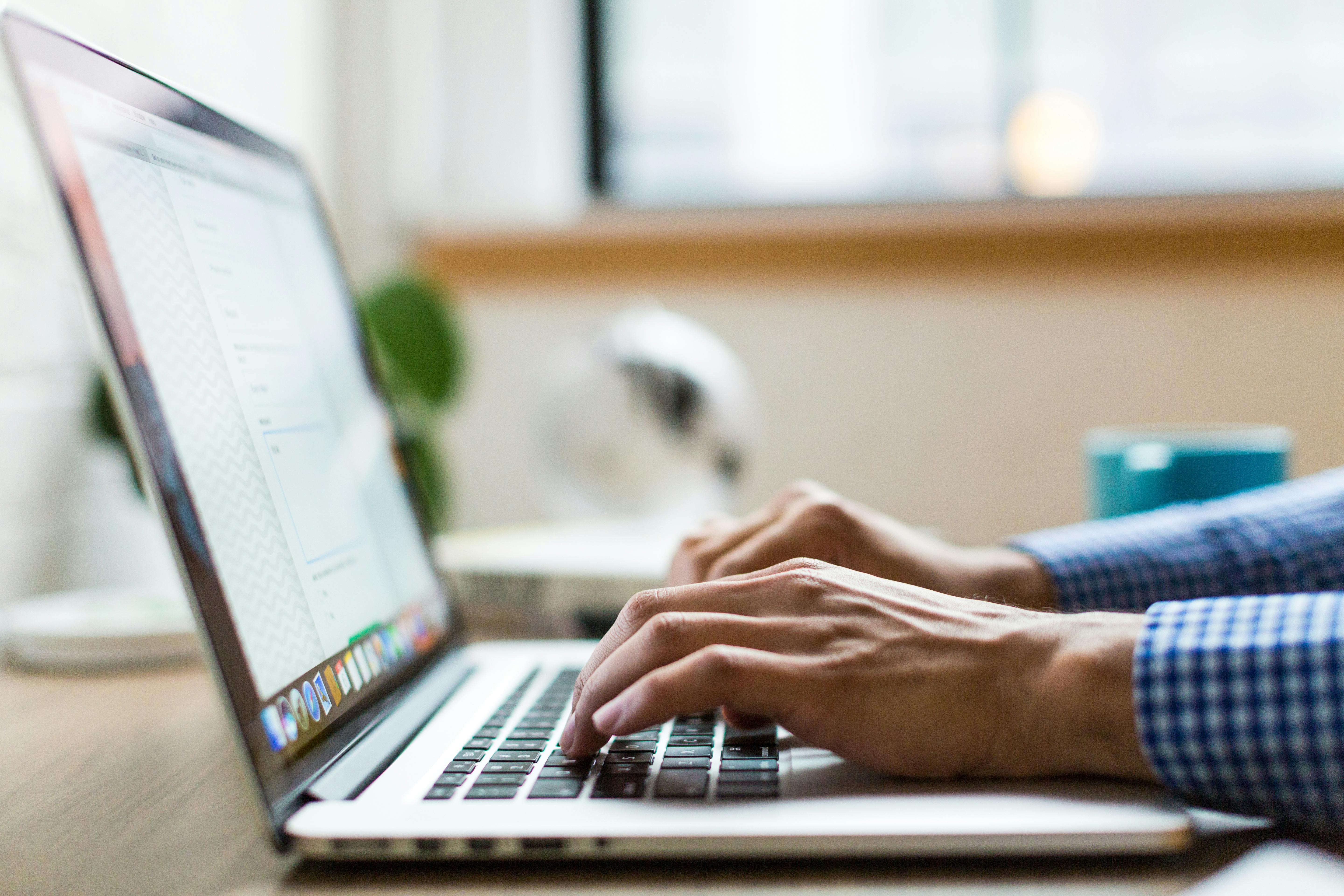 Post-event marketing strategy - person typing on their laptop to signify following up before your leads go cold. 