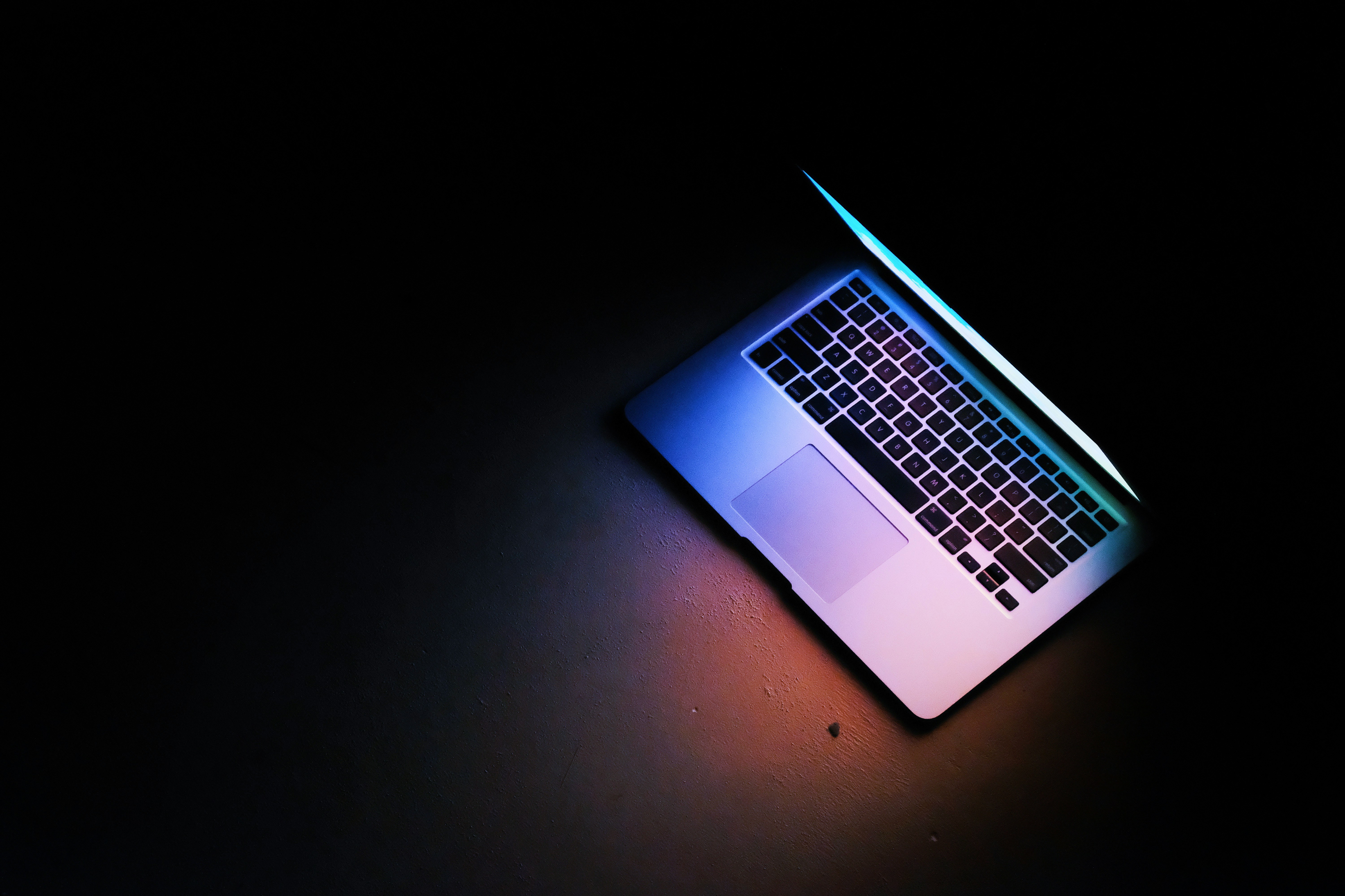 Top tier media - computer lit in dark room